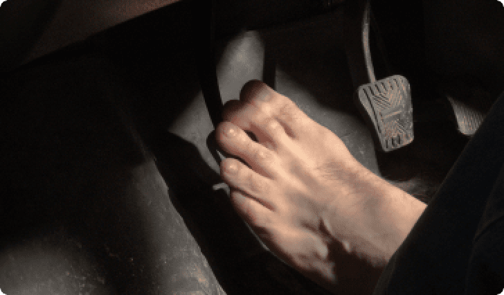 Foot on car pedal