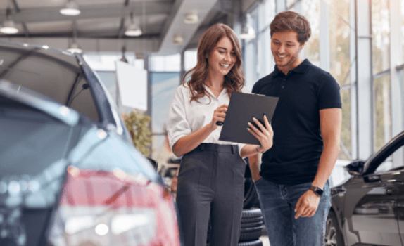 Man and woman negotiating the price of a car