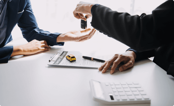 Two people exchanging car key fob
